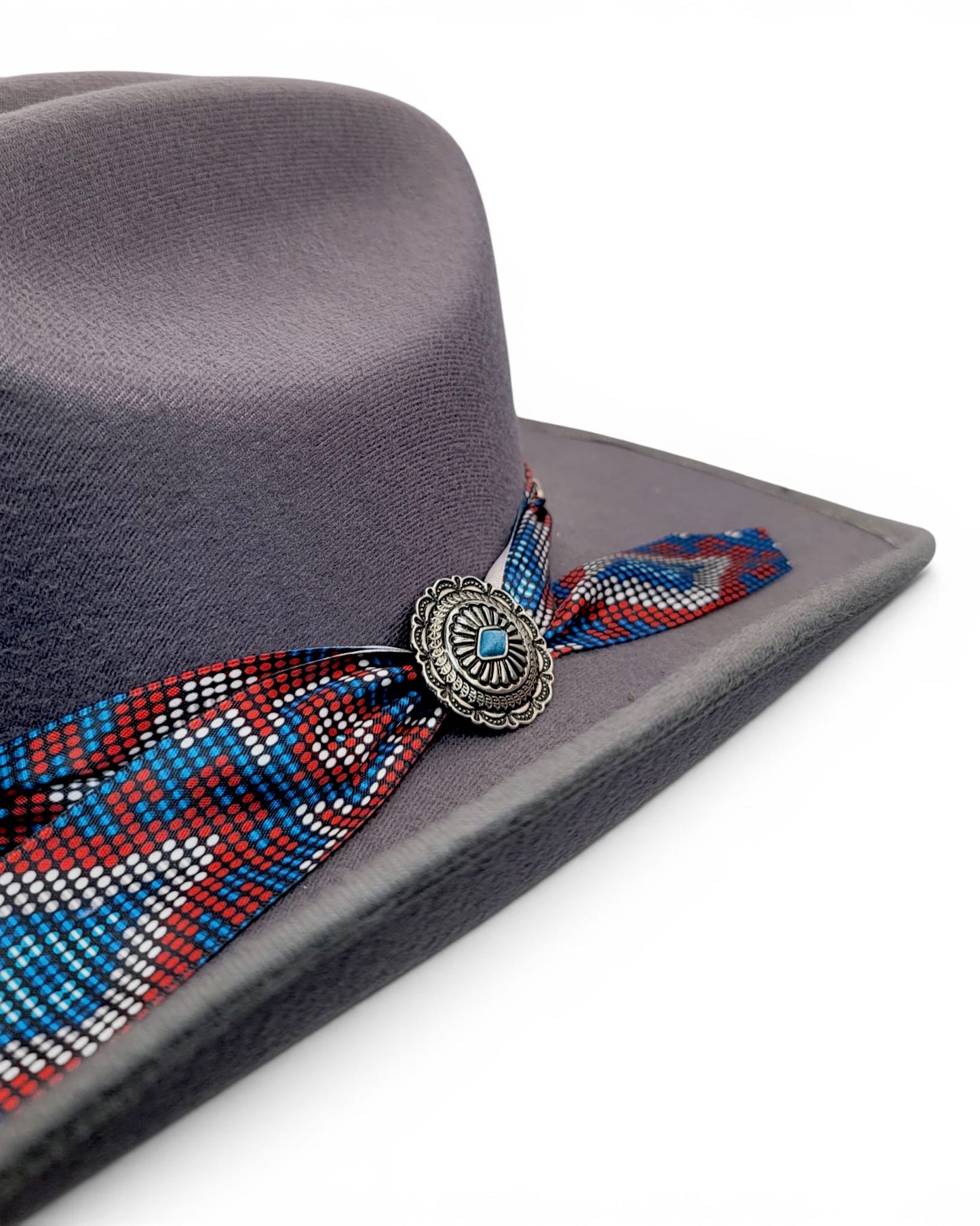 Close-up of colorful Charlie hat band and concho on women’s gray faux felt cowgirl hat