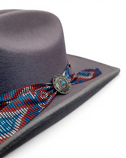 Close-up of colorful Charlie hat band and concho on women’s gray faux felt cowgirl hat